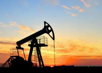 Oil drilling derricks at desert oilfield. Crude oil production from the ground. Oilfield services contractor. Oil drill rig and pump jack. Petroleum production, natural gas, liquids, NGL, additive.